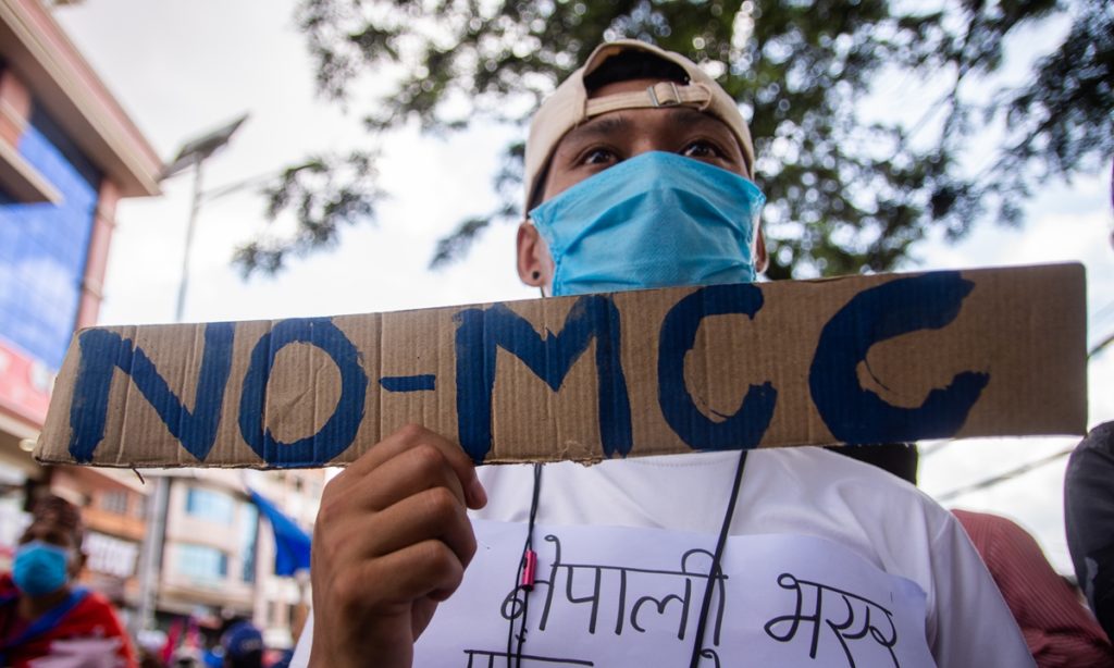 Nepalese youth holds a play card in a protest against government to cancel Millennium Challenge Corporation (MCC) agreement signed with the United States government in 2017 in Kathmandu, Nepal on Saturday, June 27, 2020. (Photo by Rojan Shrestha/NurPhoto)